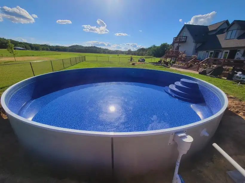 A round pool at a step corner with sun flare across the frame